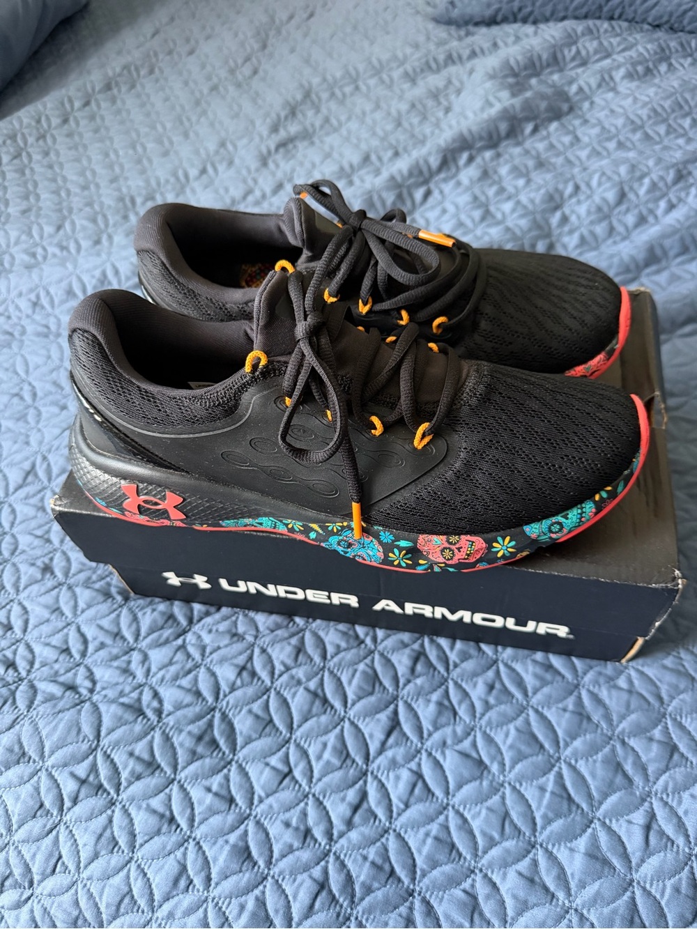 Under Armour Black Sneakers with Orange Accents and Multicolor Floral Midsole
